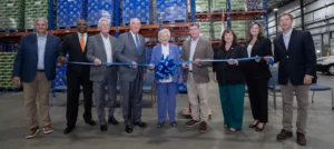 Group photo of Alabama Governor Kay Ivey and members of Department of Commerce at a ribbon cutting ceremony.
